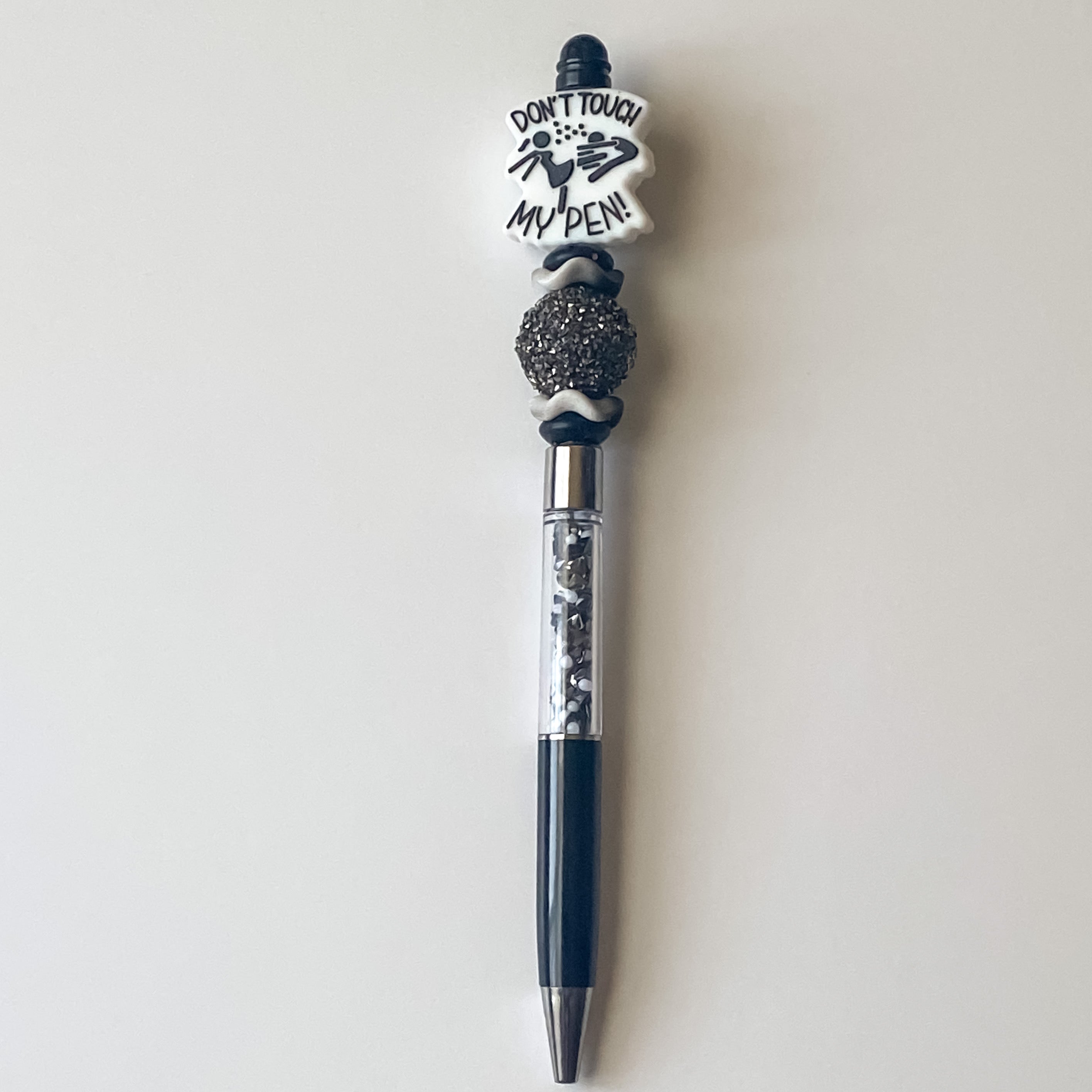 Handmade black and silver beaded pen featuring a Don’t Touch My Pen focal bead and sparkling accent bead.