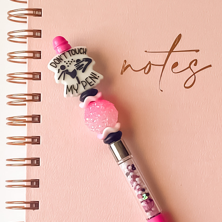 Handmade pink and white beaded pen featuring a Don’t Touch My Pen focal bead and sparkling accent bead.