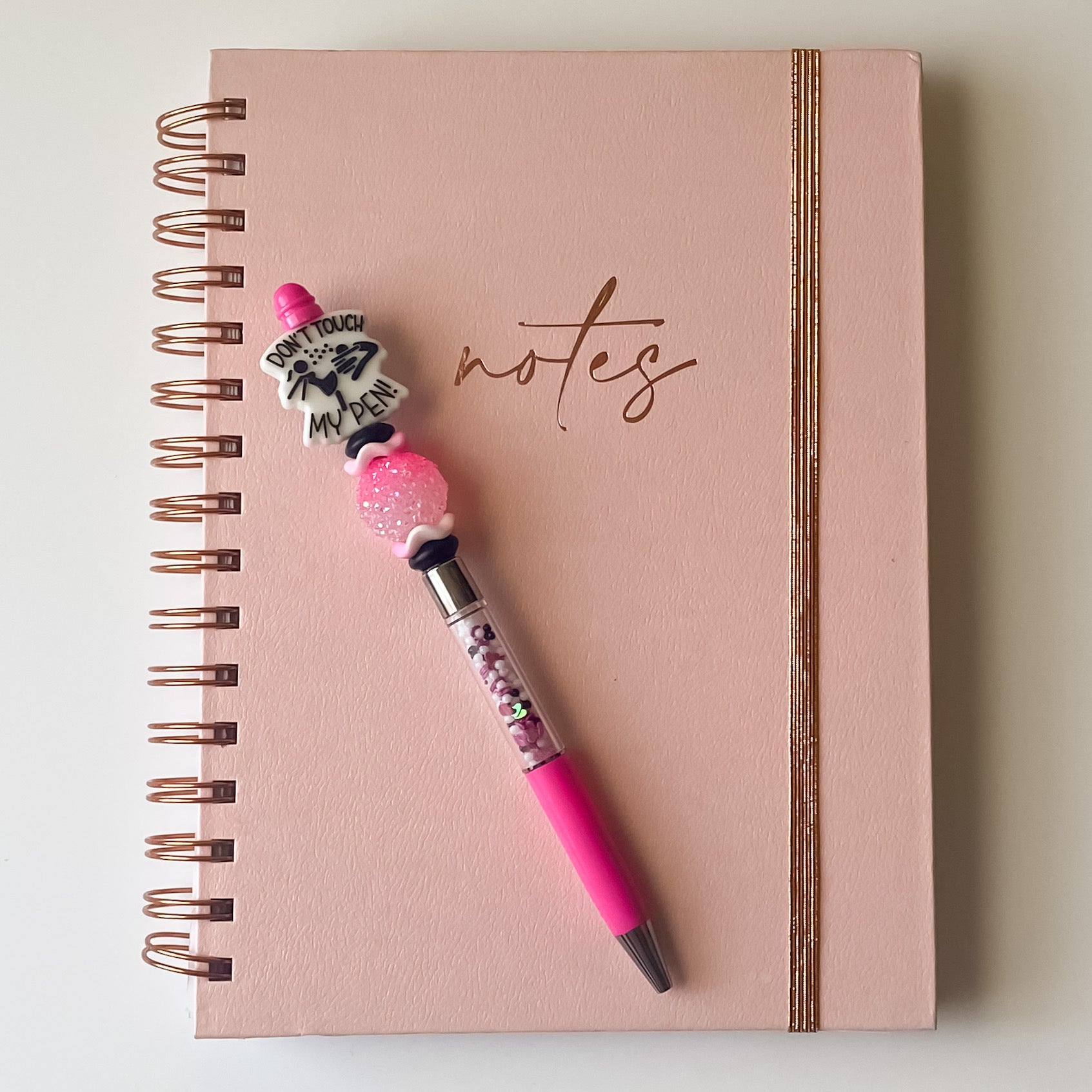 Handmade pink and white beaded pen featuring a Don’t Touch My Pen focal bead and sparkling accent bead.