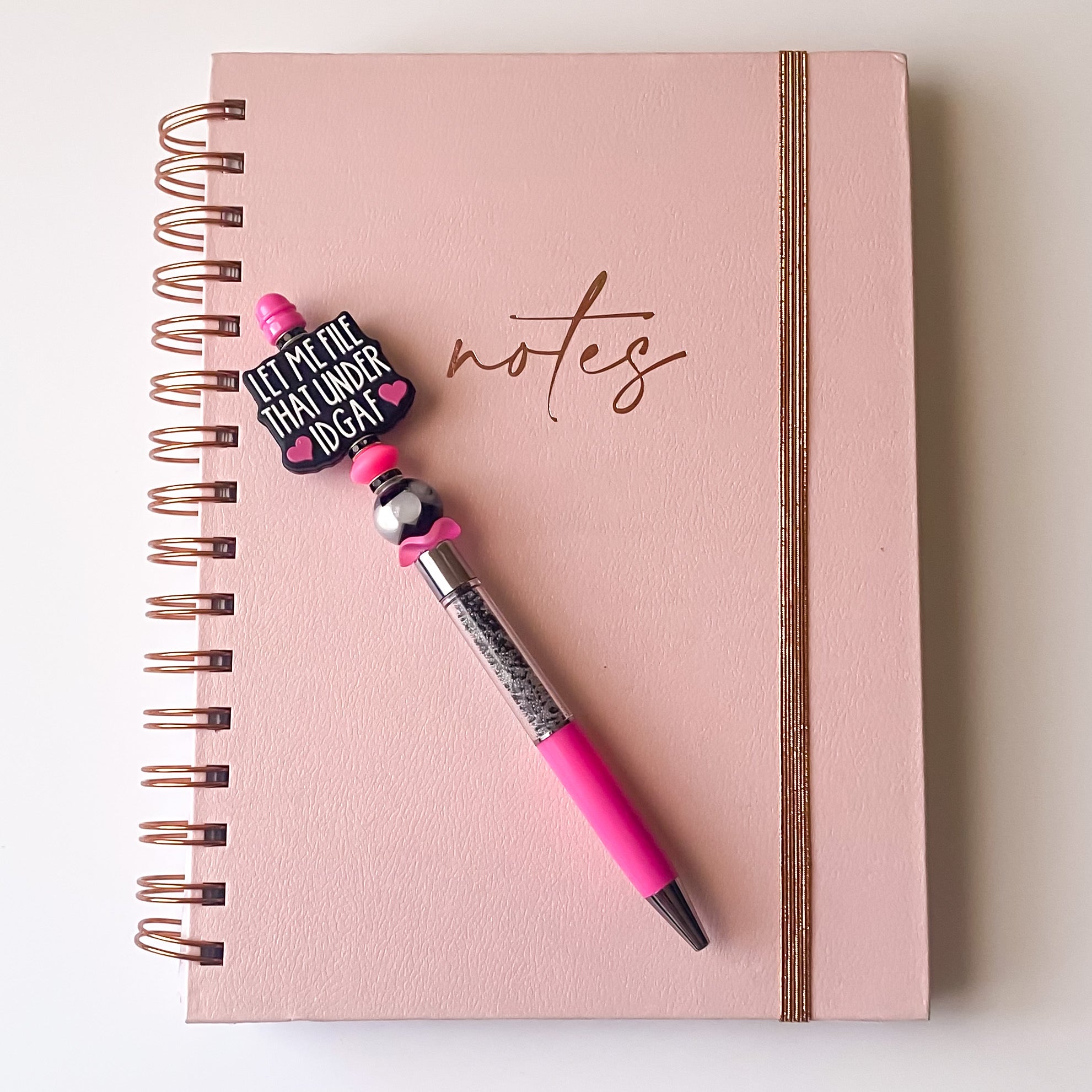 Handmade pink beaded pen featuring Let Me File That Under IDGAF focal bead with black and pink accents