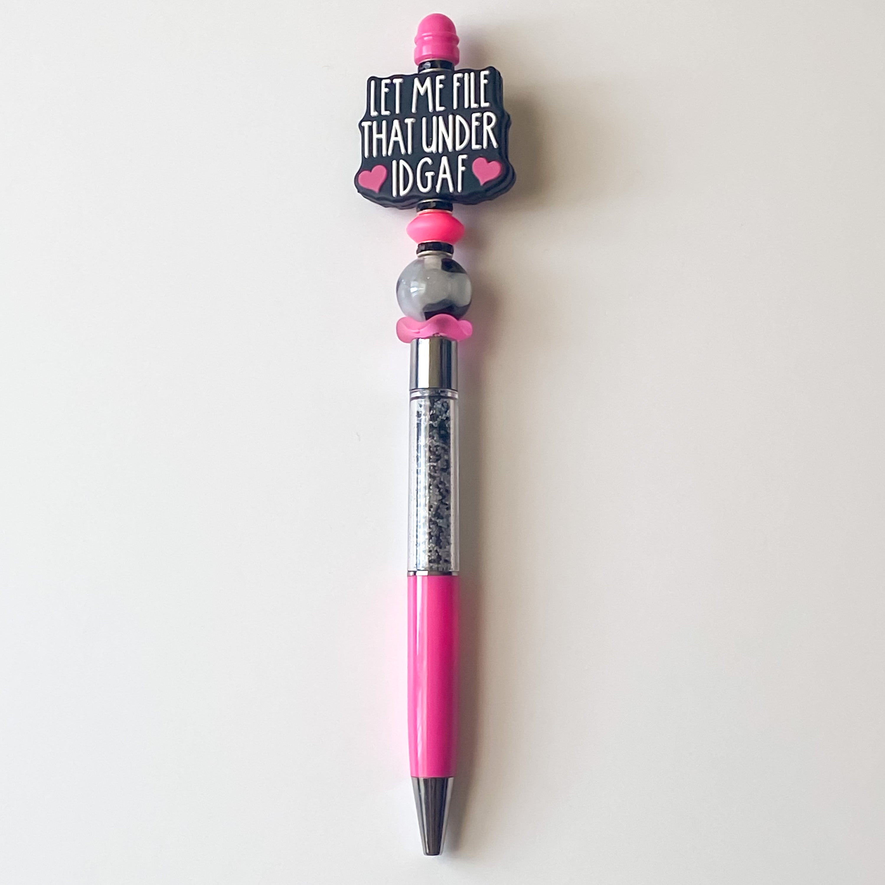 Handmade pink beaded pen featuring Let Me File That Under IDGAF focal bead with black and pink accents